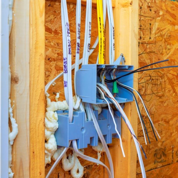 Workers,Are,Installing,Junction,Box,Wires,In,Wall,During,Home